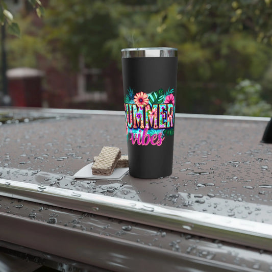 Black tumbler with 'Summer Vibes' design on a wet surface outdoors