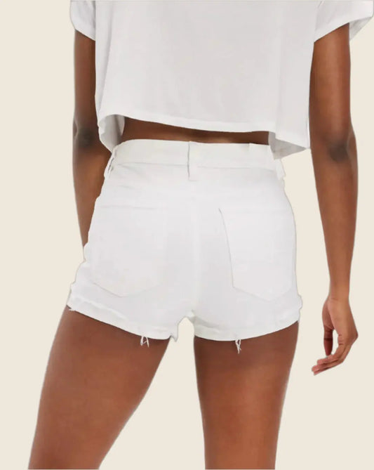 White shorts worn by a person on a beige background