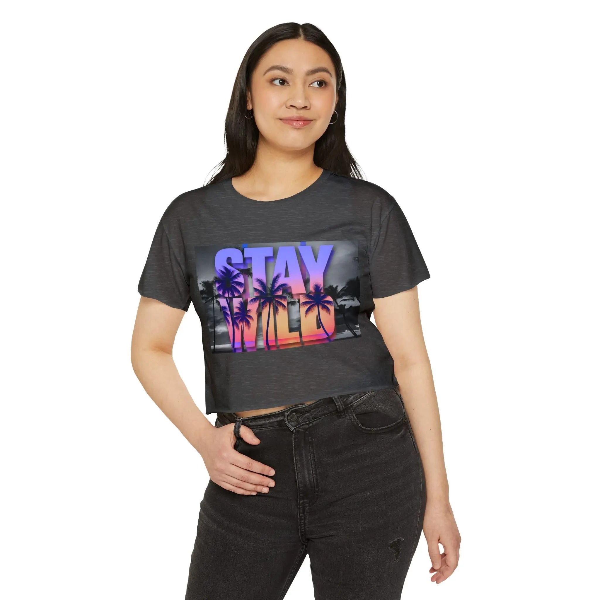 Woman wearing a grey crop top with a colorful 'Stay Wild' graphic design on a white background