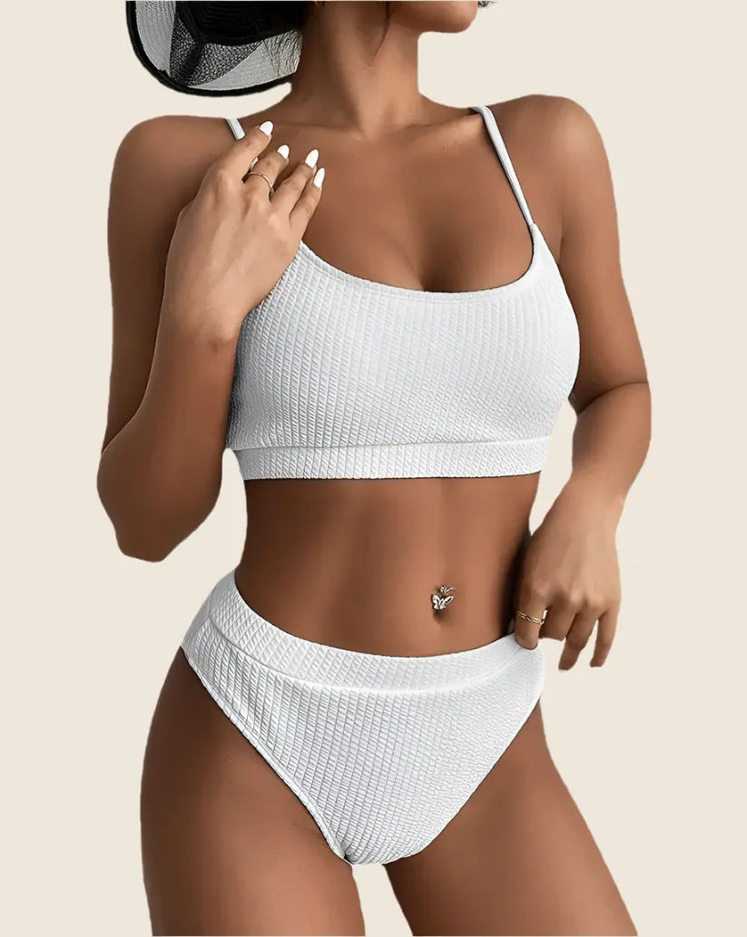 Woman wearing a white bikini set on a beige background