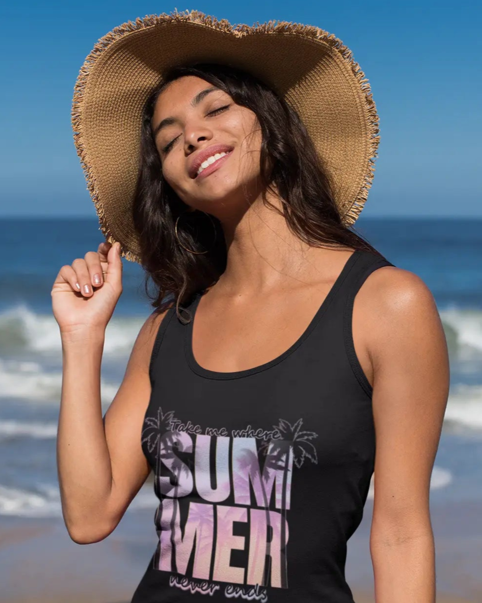 Woman wearing a black tank top with 'Take me where Summer never ends' text on a beach