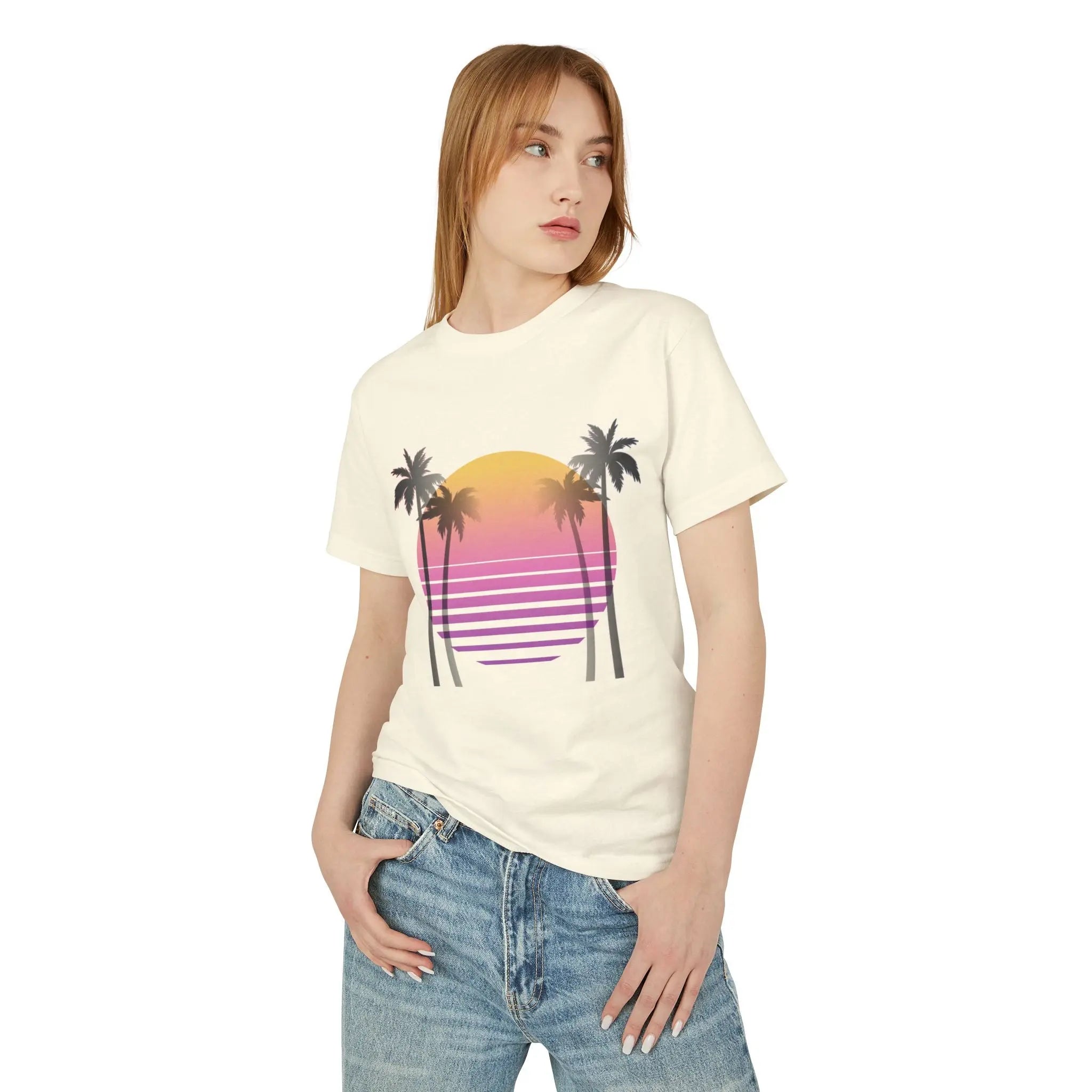 Woman wearing a cream t-shirt with a palm tree and sunset design on a white background