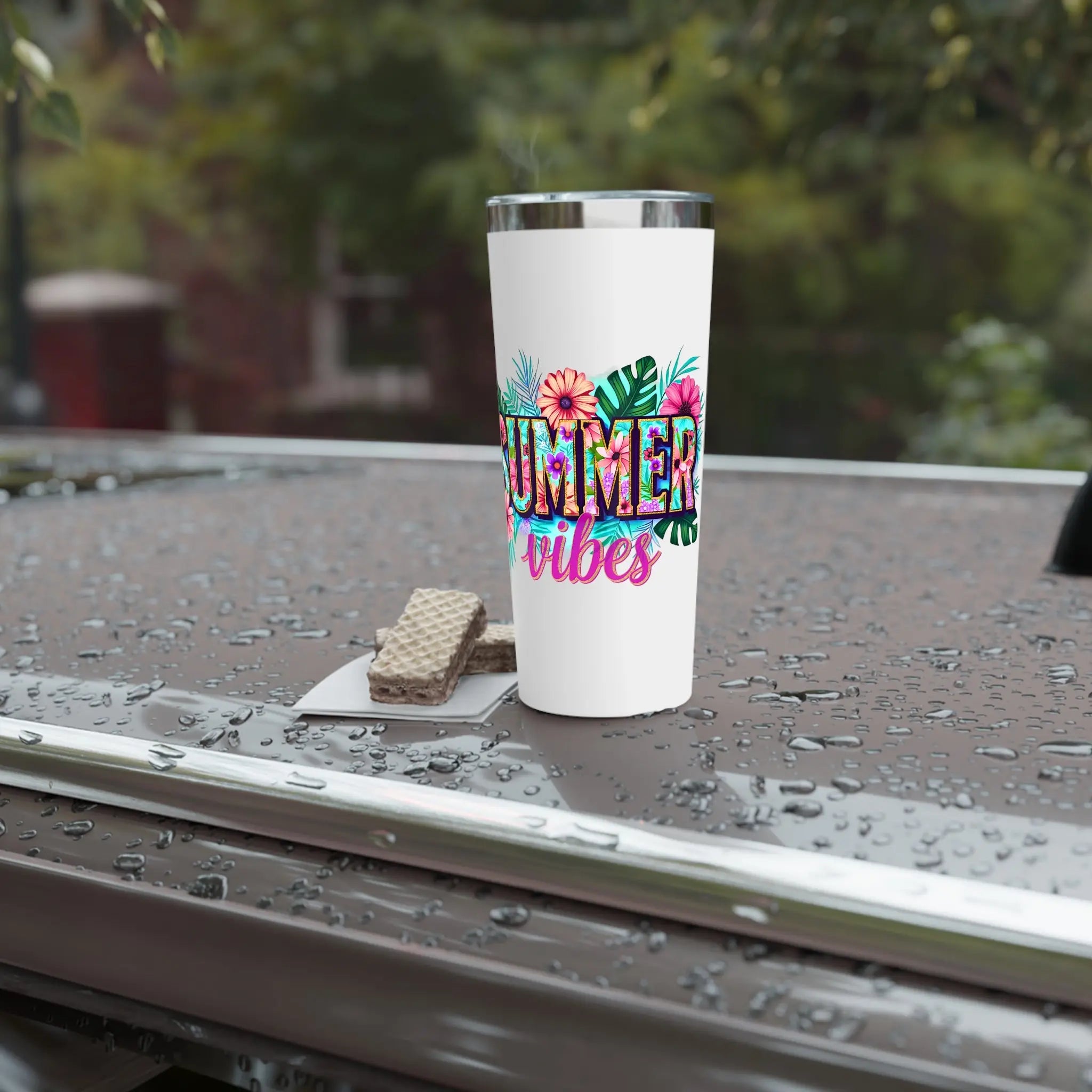 White tumbler with 'Summer vibes' design on a wet surface outdoors