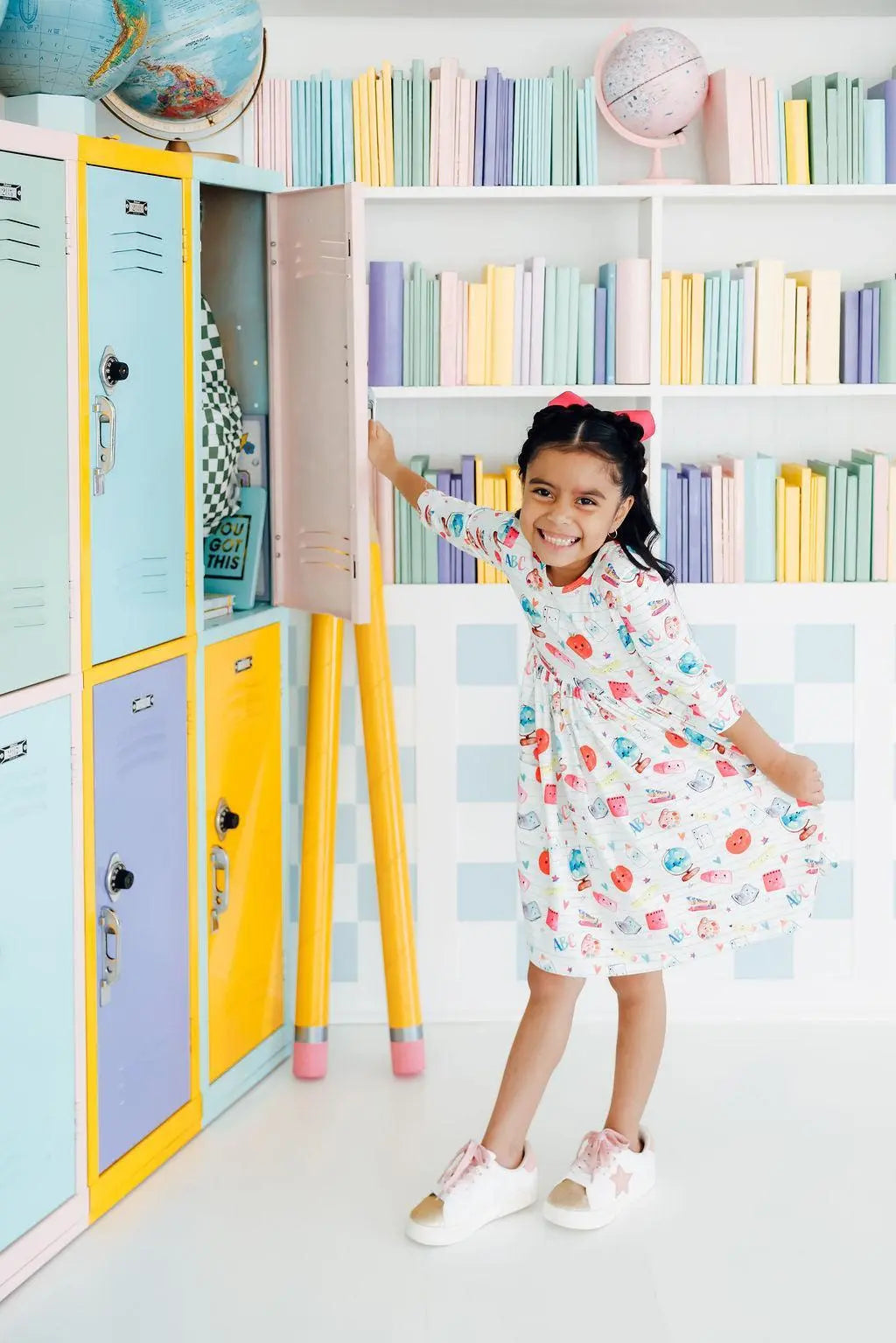 Child in a colorful room with lockers and bookshelves