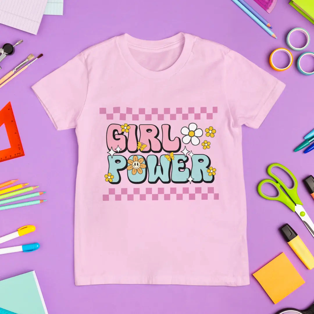 Pink t-shirt with 'Girl Power' text on a purple background with stationery items.