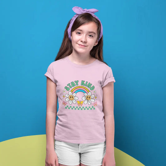 Young girl wearing a pink t-shirt with a colorful design on a blue background