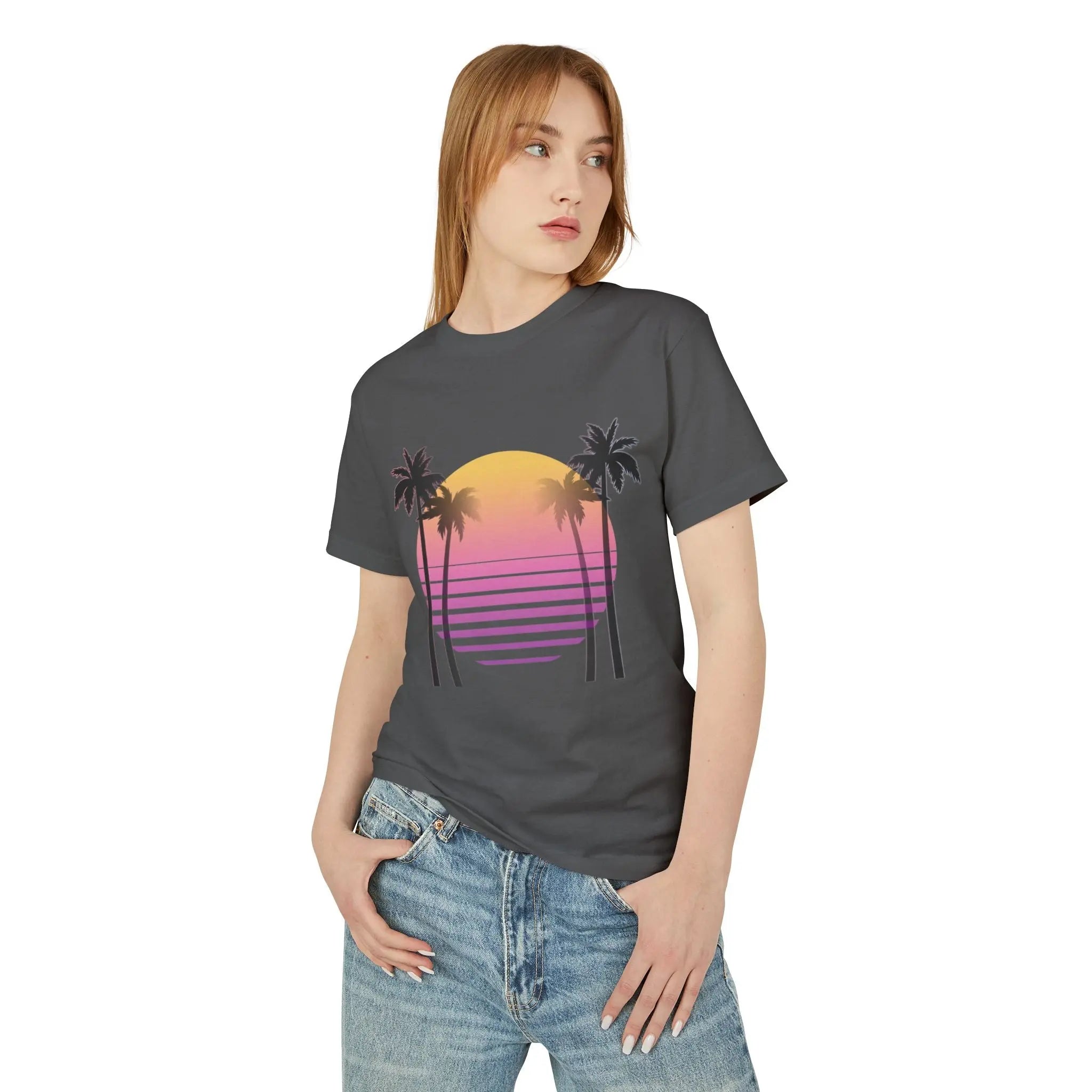 Person wearing a dark gray t-shirt with a palm tree and sunset design on a white background