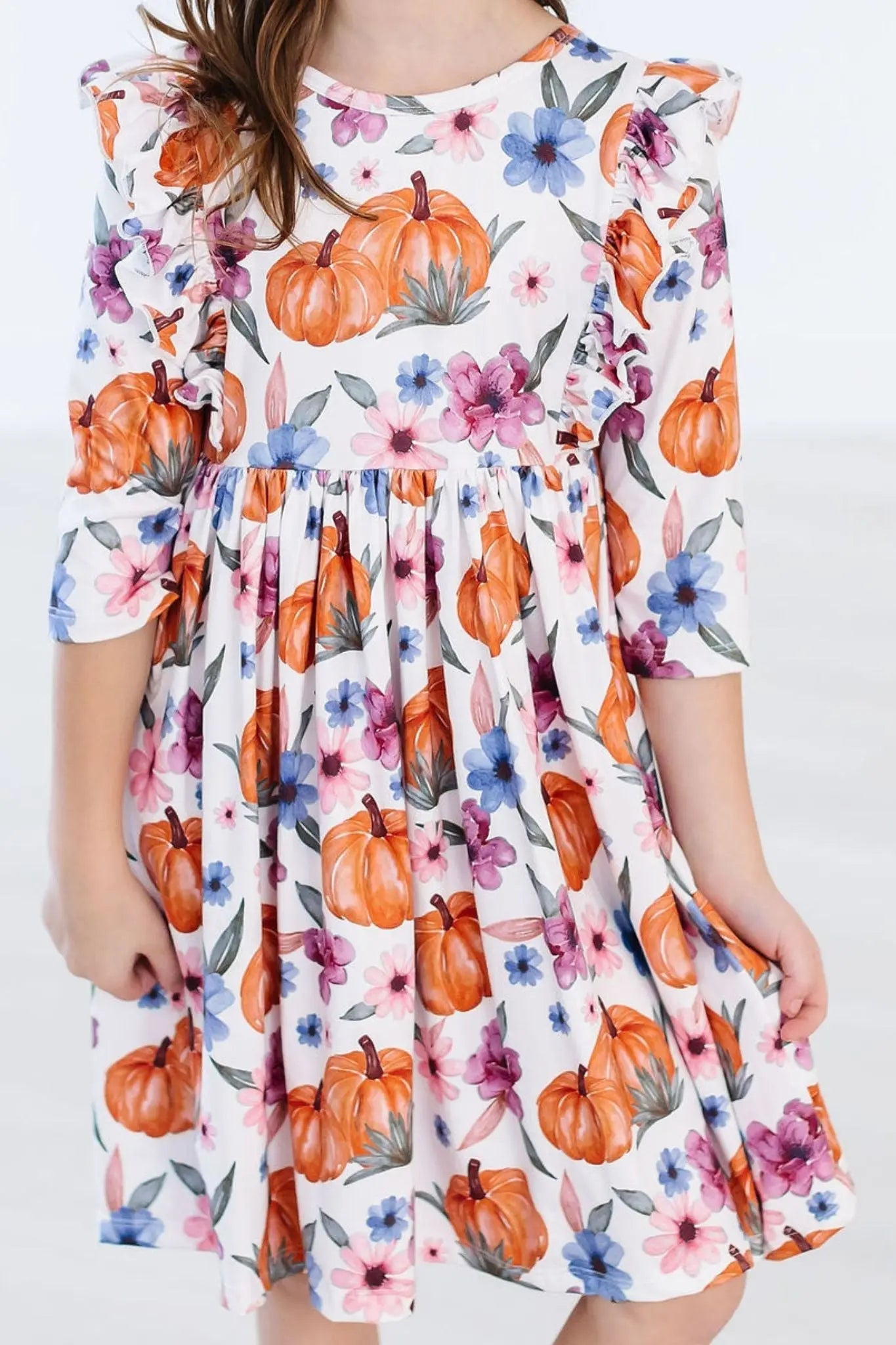Dress with pumpkin and floral pattern on a white background