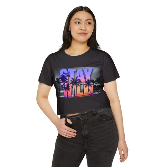 Woman wearing a black t-shirt with a colorful 'Stay Wild' graphic design on a white background