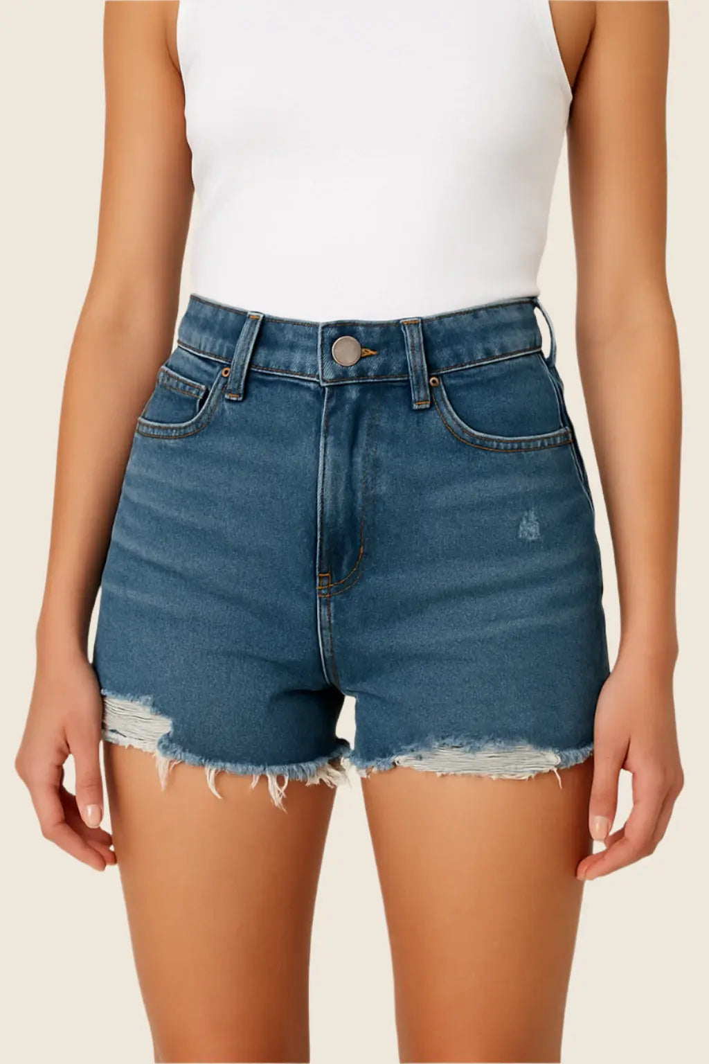 Person wearing blue denim shorts on a beige background