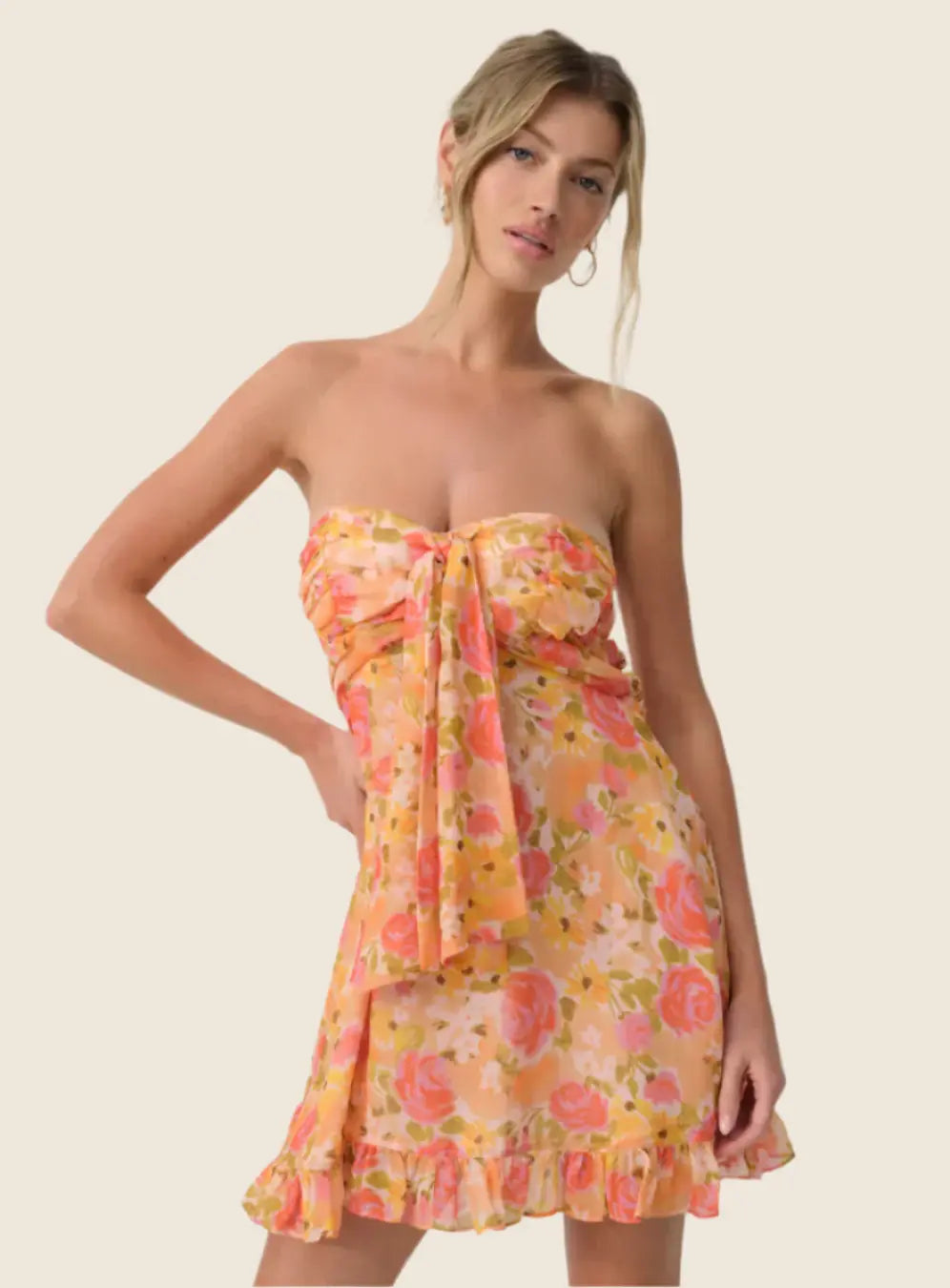 Woman wearing a floral strapless dress on a beige background