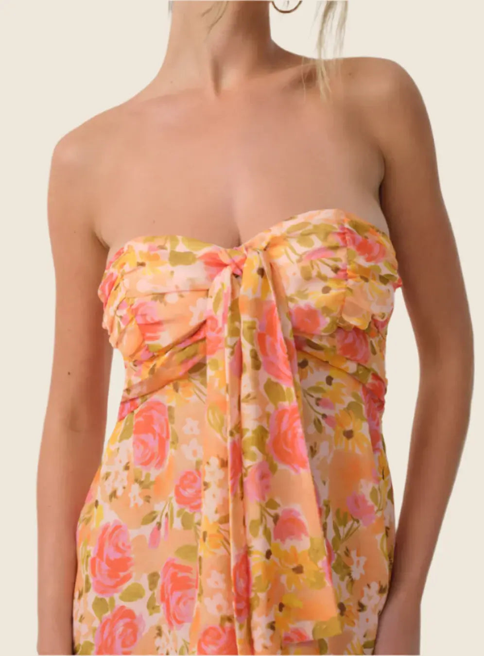 Floral strapless dress with pink and orange flowers on a plain background
