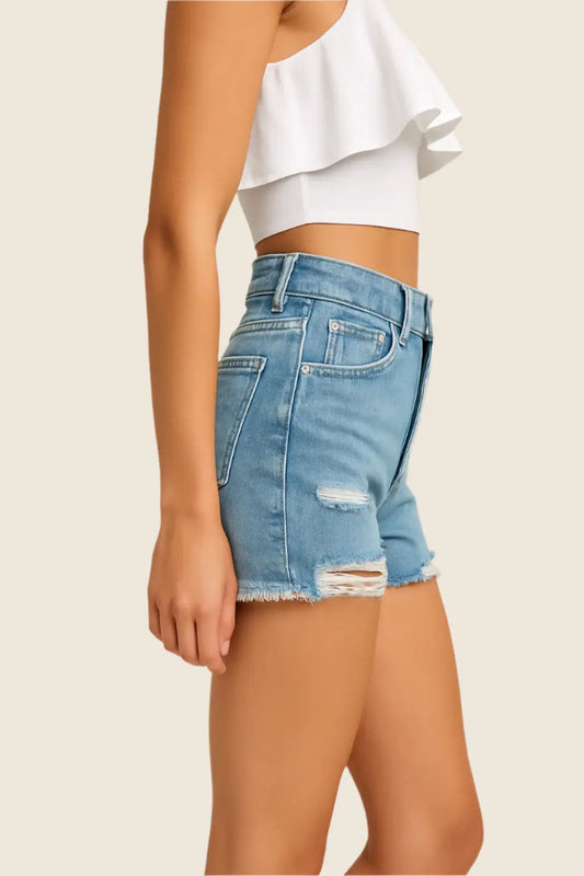 Denim shorts worn by a person on a beige background
