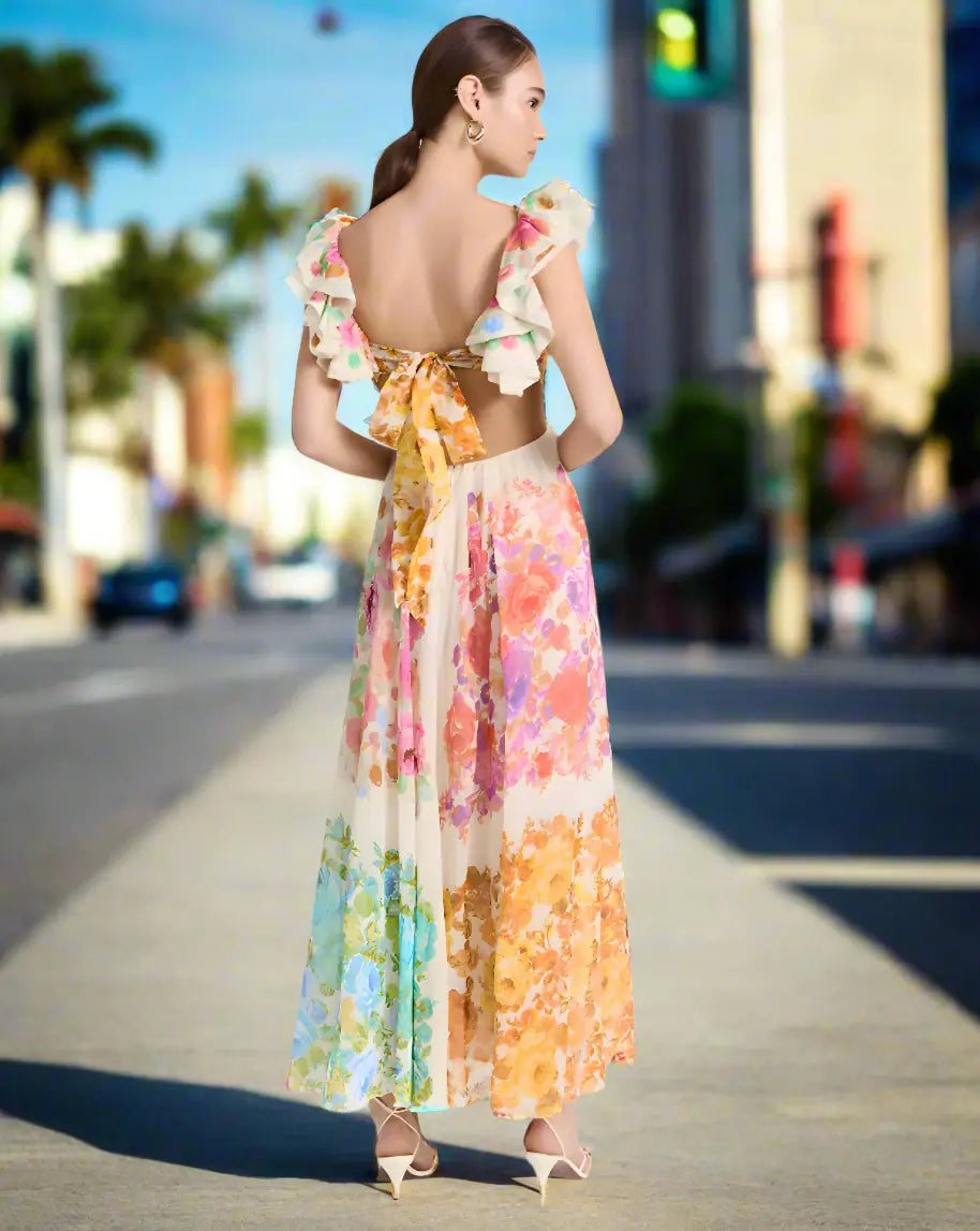 Woman wearing a colorful floral dress on a city street background