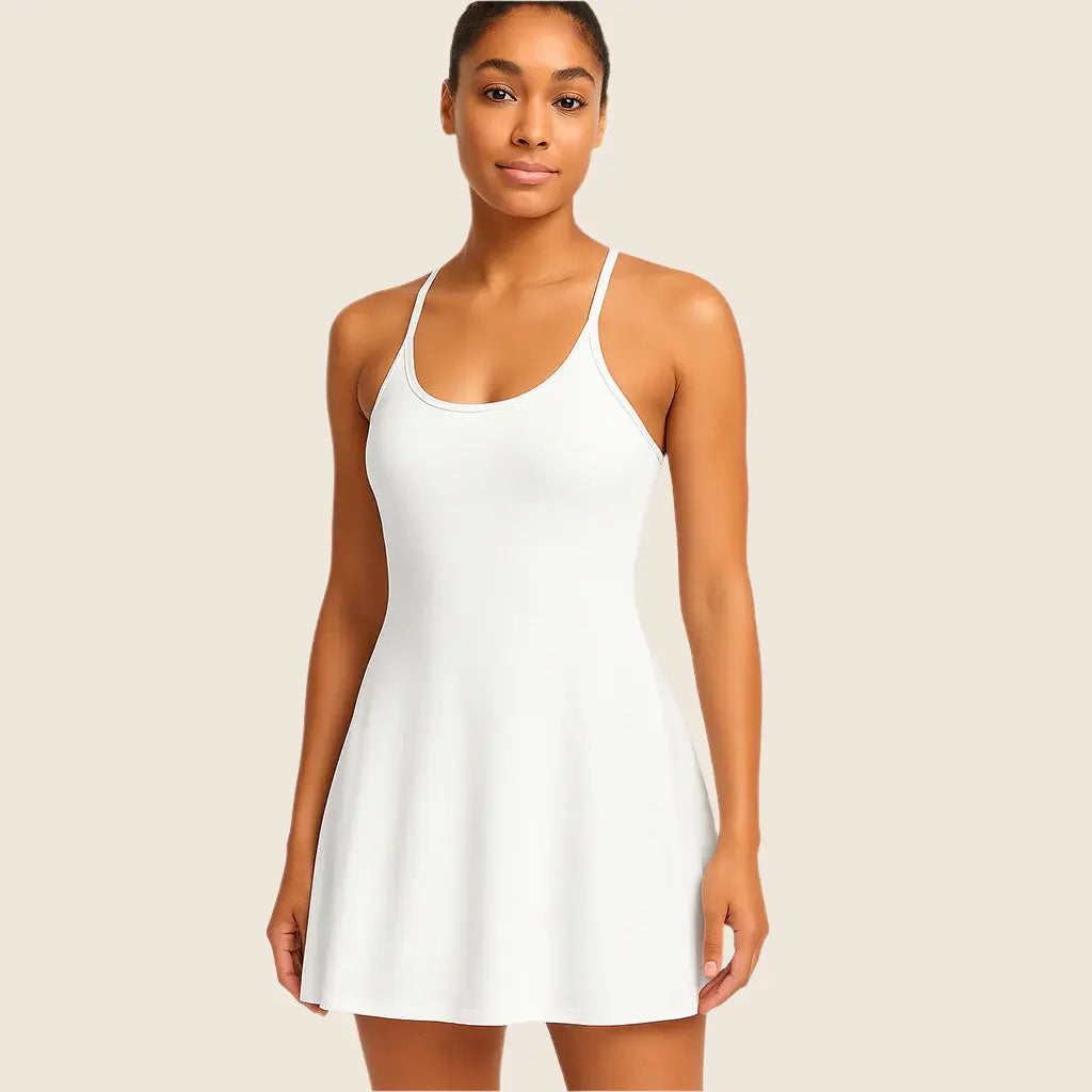 Woman wearing a white tank dress against a beige background