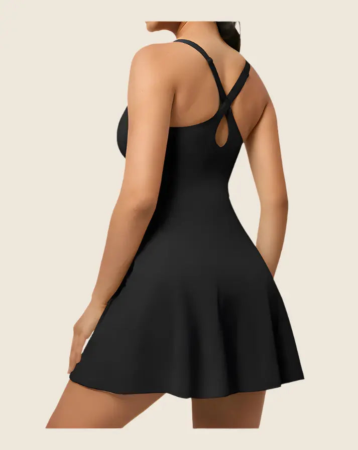 Black dress with thin straps on a beige background