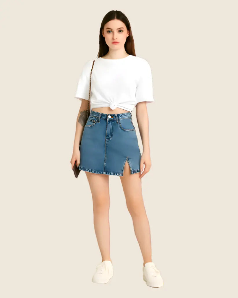 Woman wearing a white top and blue denim skirt on a beige background